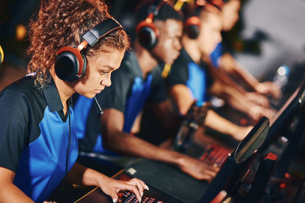 Focused,female,cybersport,gamer,wearing,headphones,participating,in,esport,tournament,